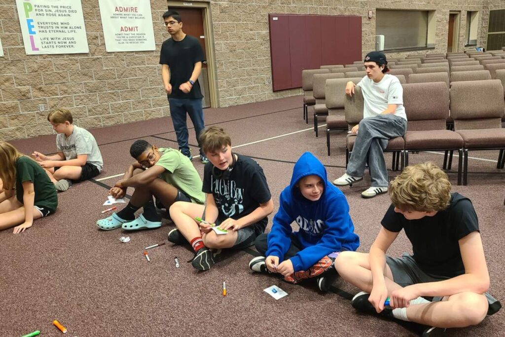 Youth Leadership Network kids sitting in a line doing an activity